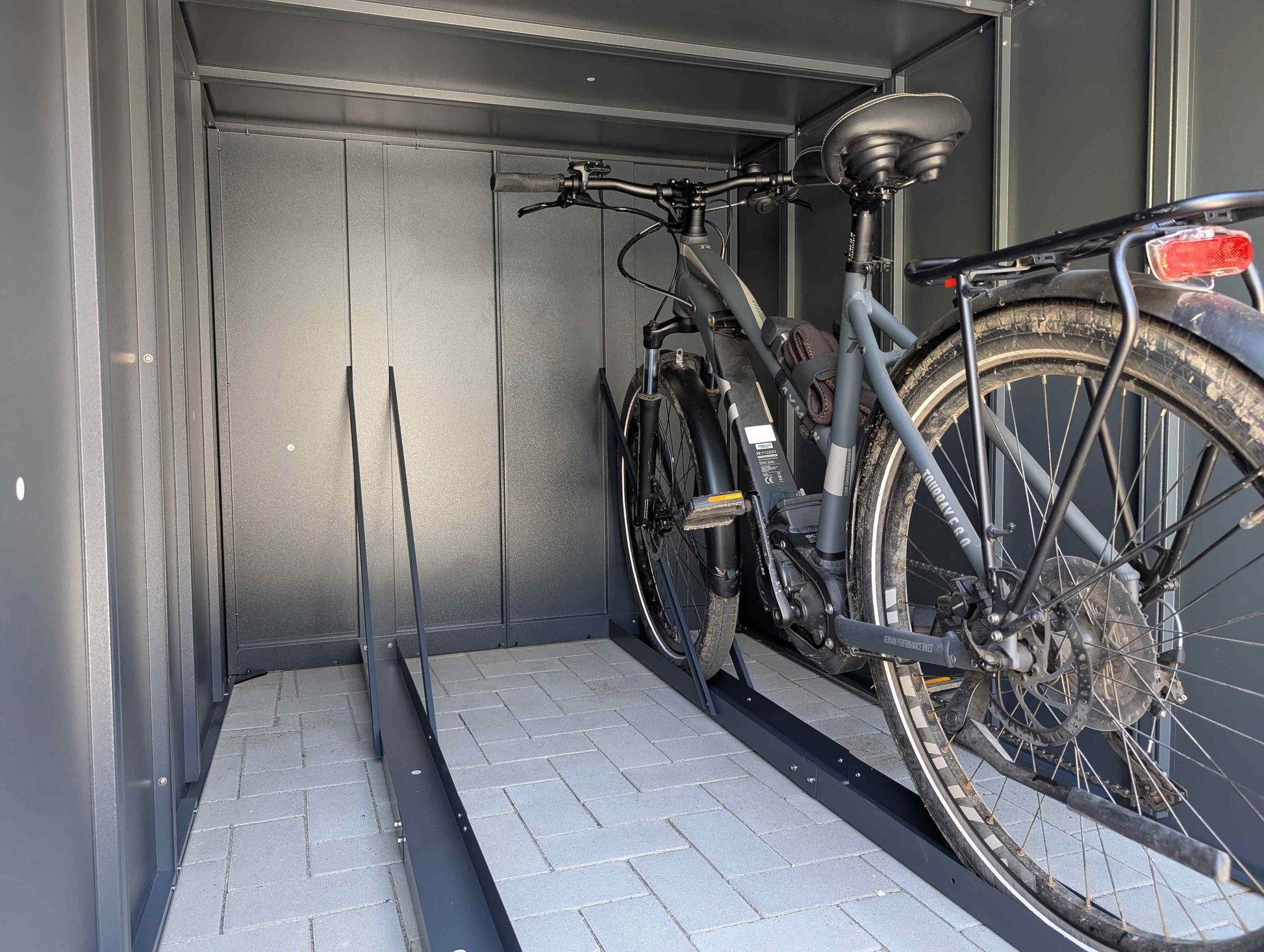 Innenansicht der Fahrradgarage E-Bike mit eingestelltem E-Bike in der E-Bike Fahrrad Führungsschiene