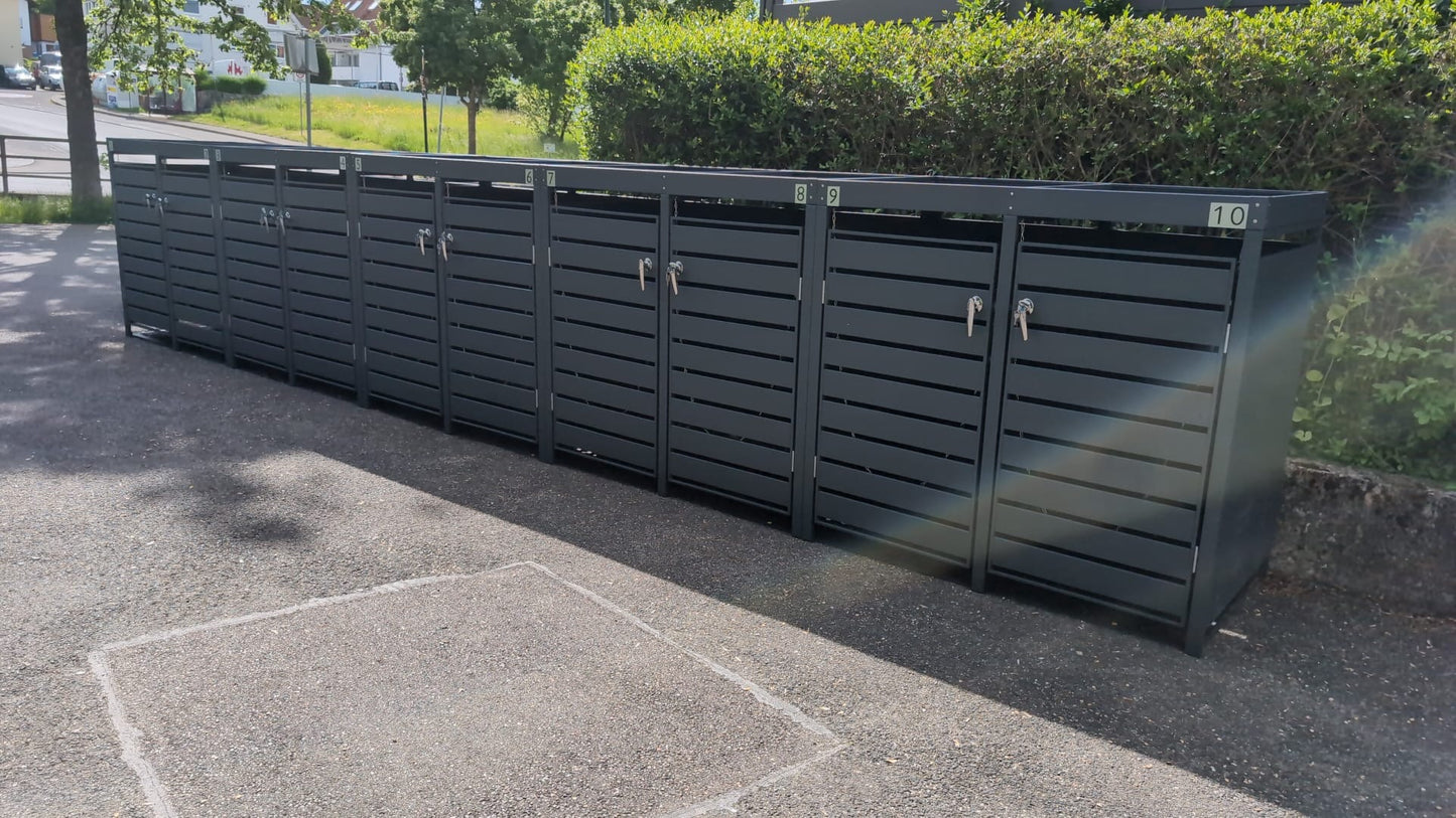 Große Reihenanlage der Mülltonnenbox Basic in Anthrazit mit Pflanzwanne, Chromgriffen und Schlössern, professionell montiert im Außenbereich.